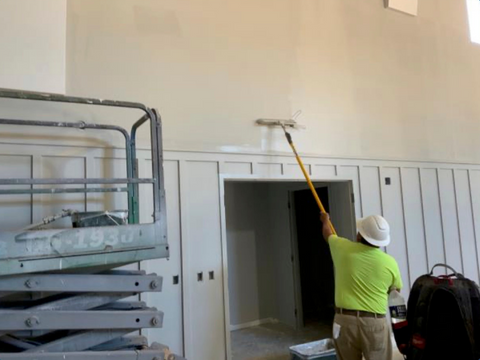 Man painting interior walls of multi-purpose (sanctuary) room